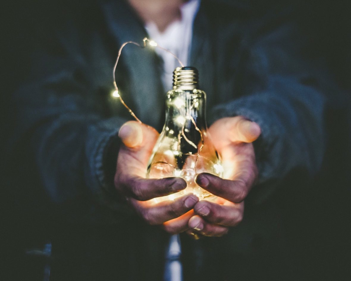 Person holding lightbulb. Riccrado Annandale, Unsplash.