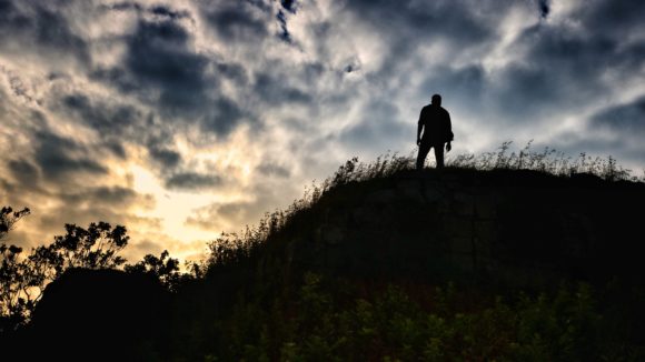 Person on hill in sunset. Manjunath Naragund, Unsplash.